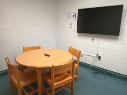 Table and chairs with monitor