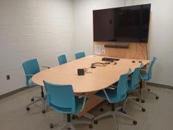 Table and chairs with monitor and whiteboard