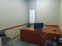 Study room with table, chairs, computer, and whiteboard