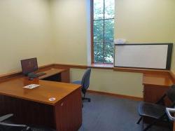 Study room with table, chairs, computer, and whiteboard