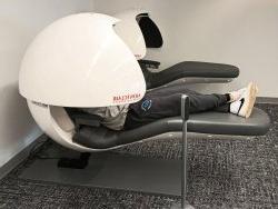 student lying in nap pod