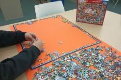 person working on jigsaw puzzle